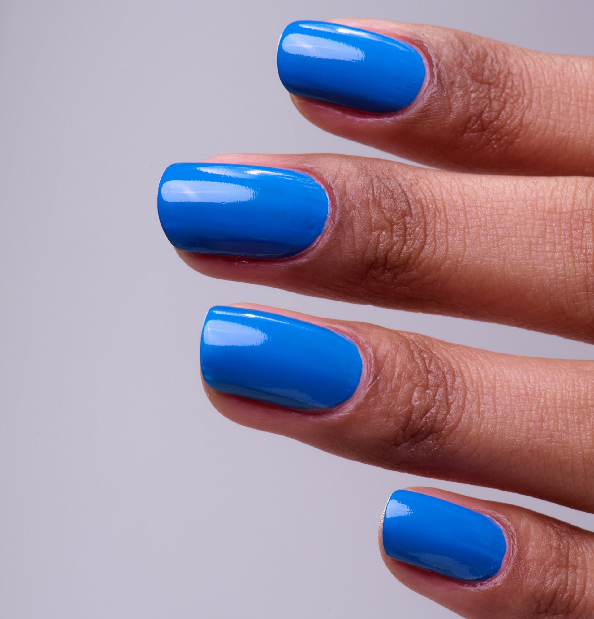 Main portant le vernis Be Green Bleu Profond. Réf. VGREE113